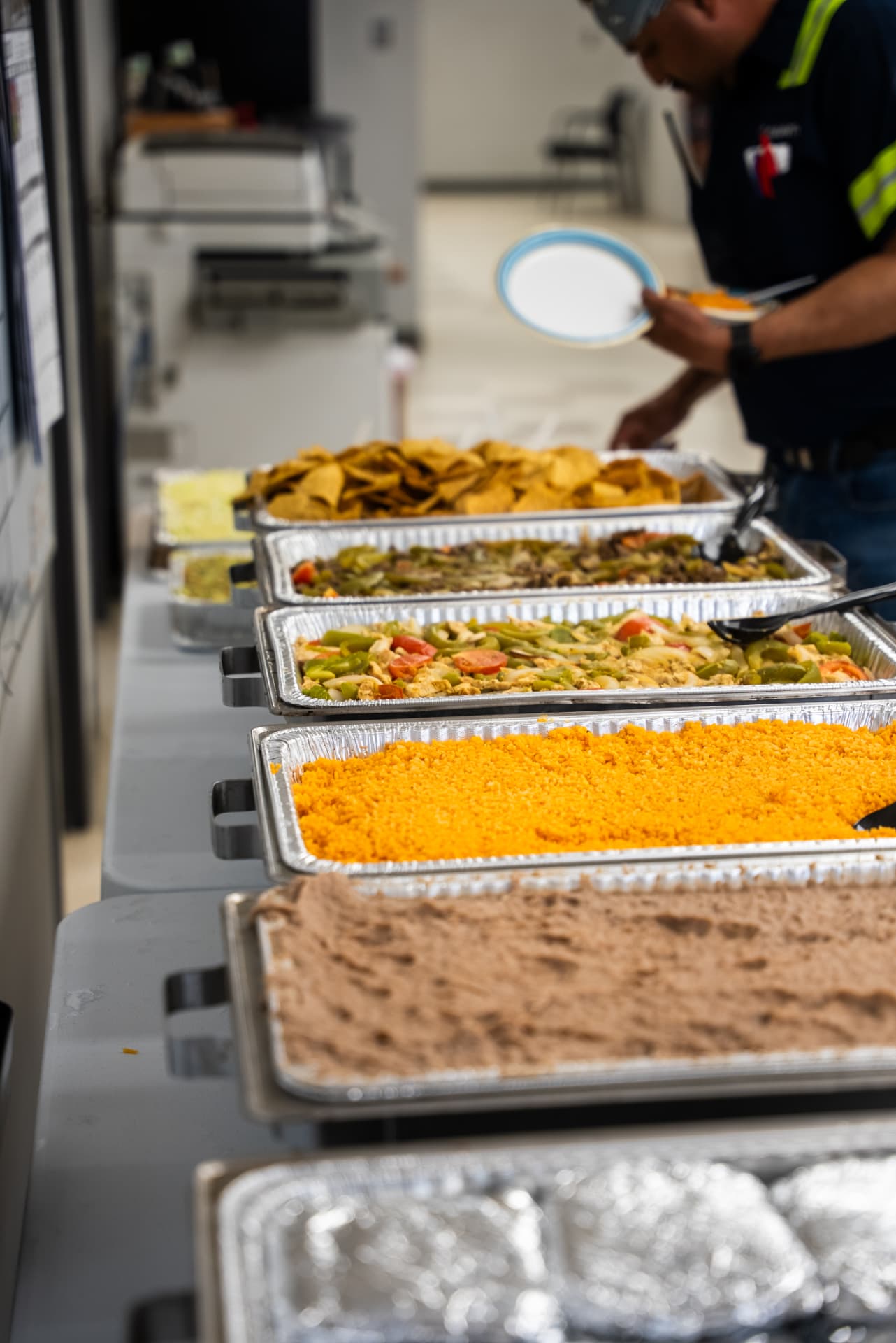 Taco Dale Fajita Bar catering spread with fajitas, tortillas, rice, beans, guacamole, toppings, and salsa